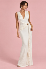 Vestido largo blanco con escote de pico pronunciado, fruncidos y detalle dorado