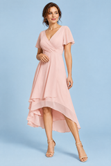 Vestido rosa con mangas de volantes y bajo asimétrico