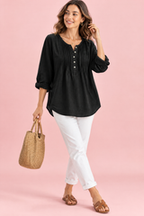 Blusa negra de algodón con cuello redondo y pliegues